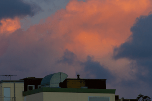Sunset over brick buildings.